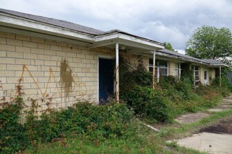 Mildred Jackson Elementary School was among those closed in Hughes last year as a result of Act 60. Today the school sits covered with vines and trashed rooms.