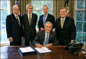 President Bush signs the America COMPETES Act on Aug. 9. Behind him are, from left, John Marburger, his science aide, Sen. Jeff Bingaman, Rep. Bart Gordon, and Sen. Pete V. Domenici.