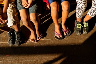 Students sit outside the principal’s office at Naalehu Elementary School. The rural school has many low-income students; some may arrive at school with no shoes.