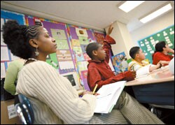 Tarijsha Janey, a history teacher at the school, later sits next to a student as she observes Ms. Sheppeck give the lesson.