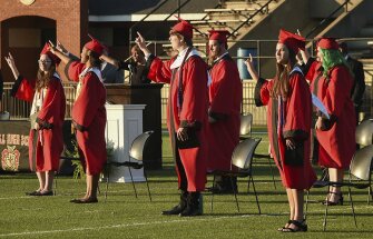 On Monday, May 12, 2020, Central High School graduates gesture during the first of five live graduation ceremonies at Garrett-Harrison Stadium in Phenix City, Ala. Over 80 graduates walked Monday night and another 400 graduates will be getting their diplomas over the next four days during similar ceremonies.