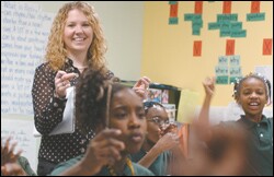 Wren Gadwa cheers along with her 5th graders after a student finishes reading his poem during the class's "Poetry Celebration" at KIPP DC:KEY Academy, one of two KIPP middle schools in Washington.