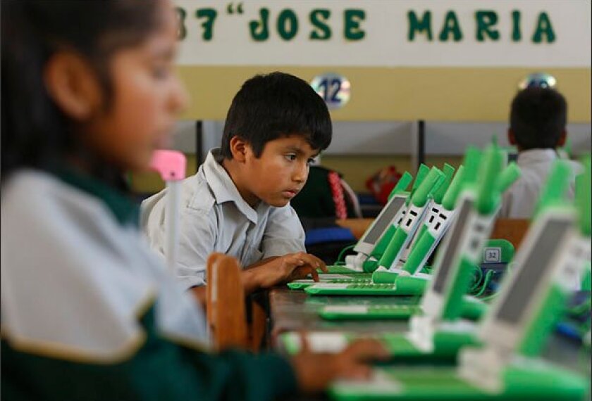 A boy uses his laptop at the Jose Maria public school in a shantytown on the outskirts of Lima, Peru. Peru has sent more than 800,000 laptop computers children across the country, one of the world's most ambitious efforts to leverage digital technology in the fight against poverty. Yet five years into the program, there are serious doubts about whether the largest single deployment in the One Laptop Per Child initiative was worth the more than $200 million that Peru's government spent.
