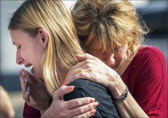 Student Dakota Shrader is comforted by her mother, Susan Davidson, following a shooting at Santa Fe High School on May 18 in Santa Fe, Texas. Ten people — 8 students and 2 teachers –were killed.