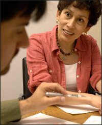 Principal David Herrera of Cesar Chavez Academy consults with Lorie Chamberland, his coach from the New Teacher Center.