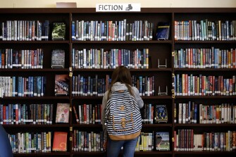 A student browses through books in the Presidio Middle School library in San Francisco, Calif. on Tuesday, Sept. 10, 2019. Salesforce provided funds to refurbish and upgrade the schoolyard and library.