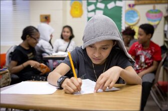 Sixth grader Carlos Esquivel, 12, works on math during the study hall portion of their after-school program at Boushall Middle School in Richmond, Va.
