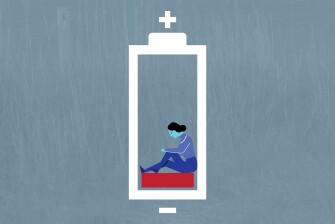 Image of an exhausted teacher sitting at the bottom of a battery showing low charge.