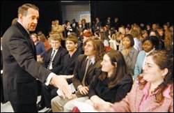 Gov. Mike Huckabee of Arkansas greets high school students at a town hall meeting on high school reform Feb. 1 in Conway, Ark. The meeting was a part of the preparation for this month's summit.