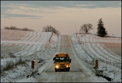 A school bus passes snow-dusted fields on a late-afternoon route in Anamosa, Iowa. Local school officials have mixed feelings about the state's hands-off approach to standards.