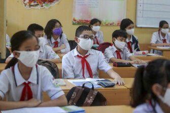 Students wearing masks attend a class in Dinh Cong secondary school in Hanoi, Vietnam Monday, May 4, 2020.