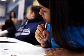 Senior Krystal Acevedo takes notes in her AP English Language and Composition class at the Washington Heights Expeditionary Learning School. This year, 100 percent of the senior class applied to college, the principal says.