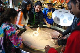 Franklin Middle School students from Vallejo, Calif., experiment with a “spinning blackboard” while on a field trip to San Francisco’s Exploratorium.