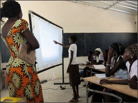 A class in Senegal utilizes a solar-powered interactive whiteboard as part of a lesson.