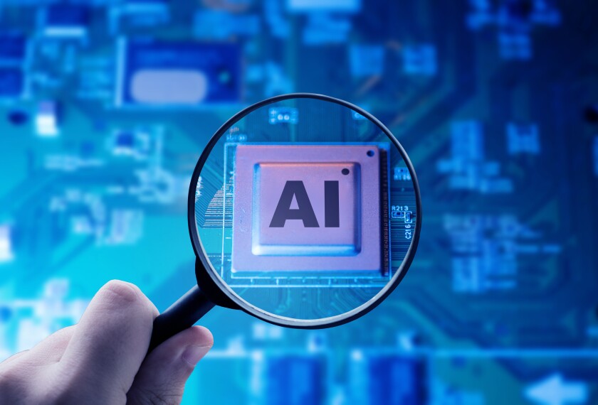 A photo illustration of a hand holding a magnifying glass that is focusing on a motherboard chip with the letters "AI".
