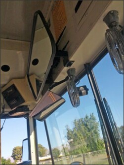 A Wi-Fi router is mounted behind the interior driver’s mirror inside this Coachella Valley Unified School District bus.